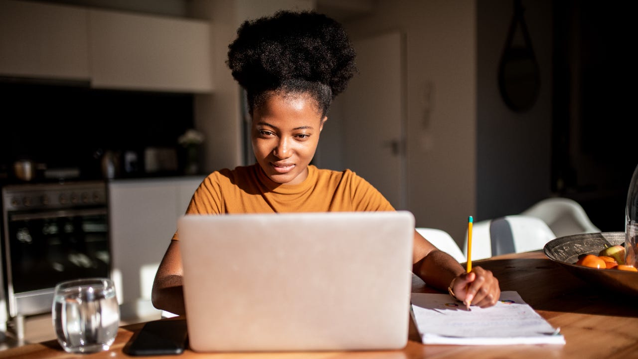 A woman researches on her laptop computer